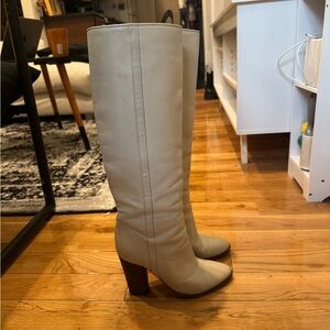 Cream colored knee high heeled leather boots
